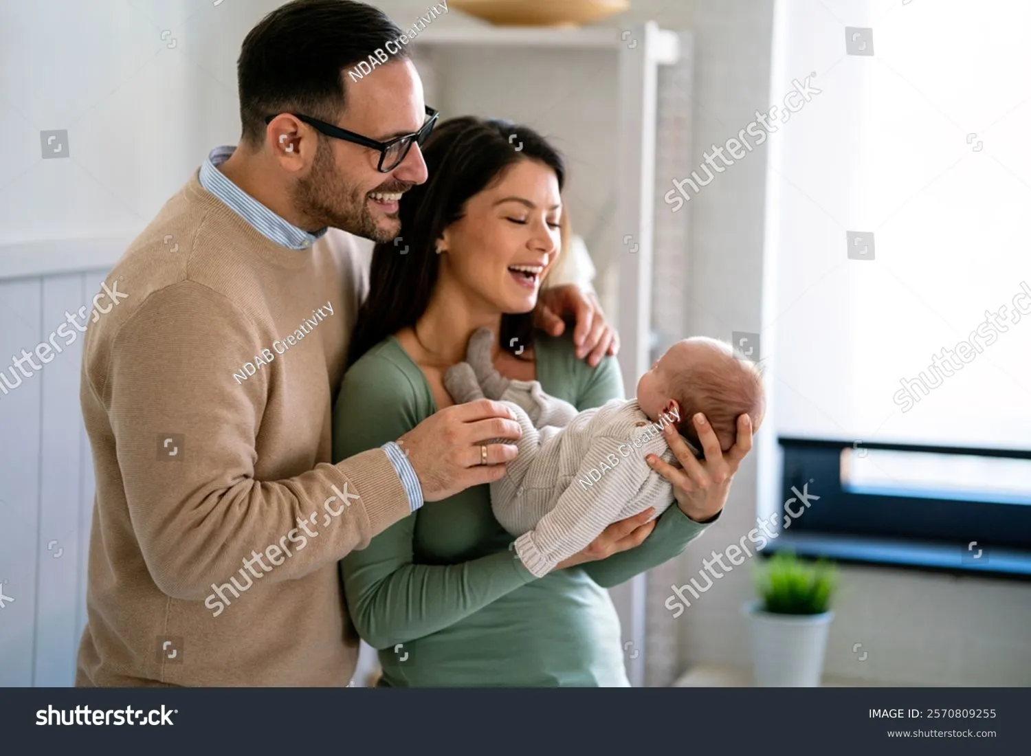 A family holding their newborn